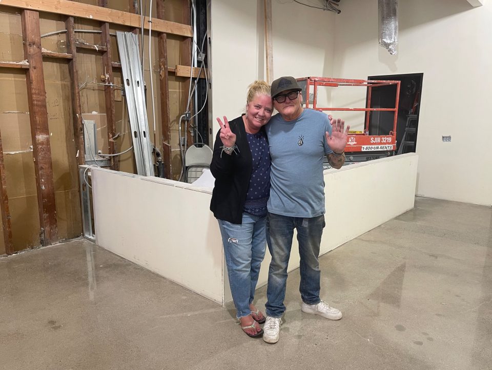 owners standing in new unfinished expansion space